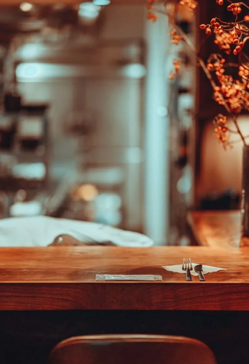 Cozy restaurant interior with elegant table setting and floral decorations, perfect for dining inspiration.